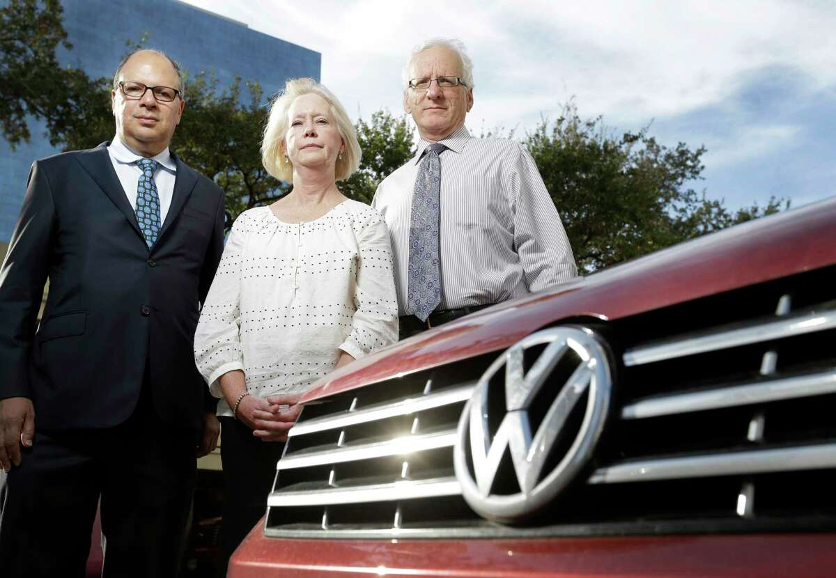 Donna Knowles poses with her attorneys Dennis Reich, left, and Richard Schechter, right, along with her 2015 Volkswagen Passat on Oct. 21, 2015.
