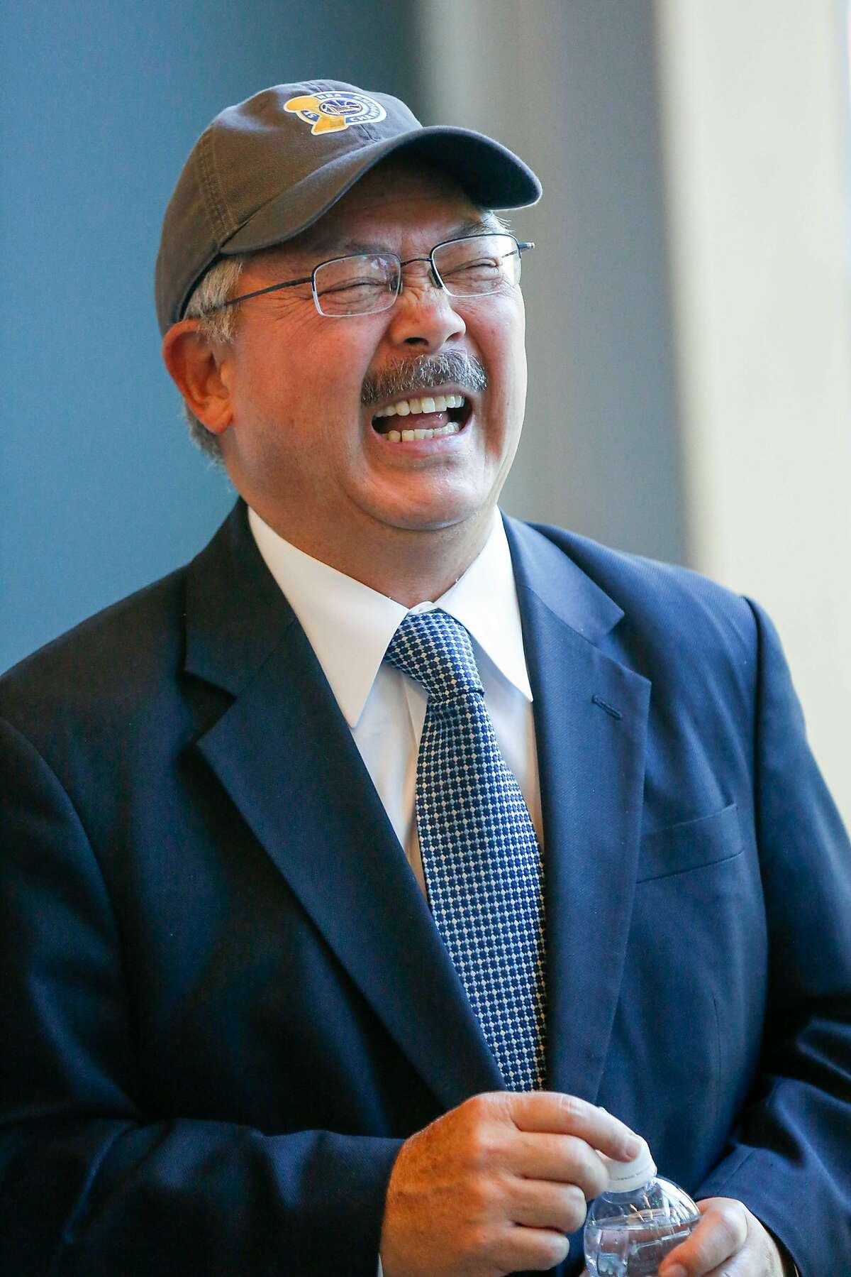 Mayor Ed Lee has a laugh with Warriors officials before a sneak peak tour of the Warriors construction site on Wednesday, November 7, 2017 in San Francisco, Calif.