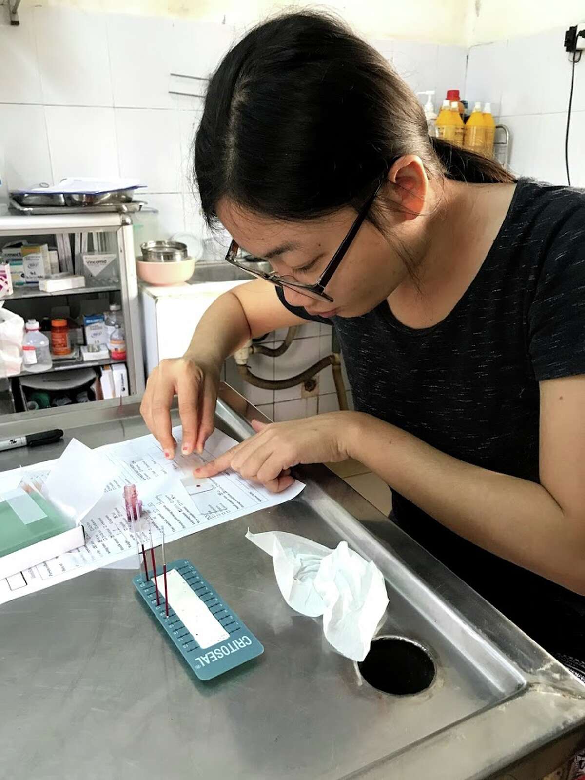 A veterinarian looks at a pangolin's blood sample at Saving Vietnam's Wildlife.