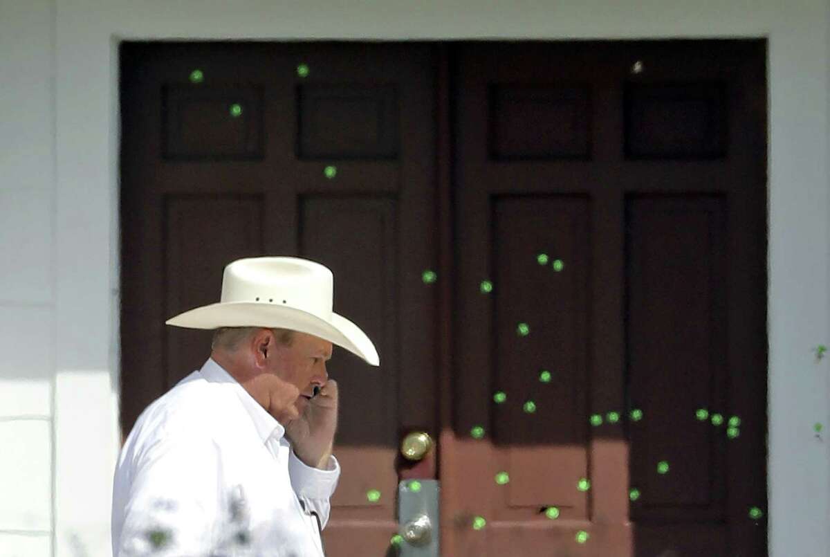 Wilson County Sheriff Joe Tackitt Jr. walks past the front doors of the First Baptist Church on Nov. 7 in Sutherland Springs, two days after the massacre that left 26 worshippers dead and 20 wounded.