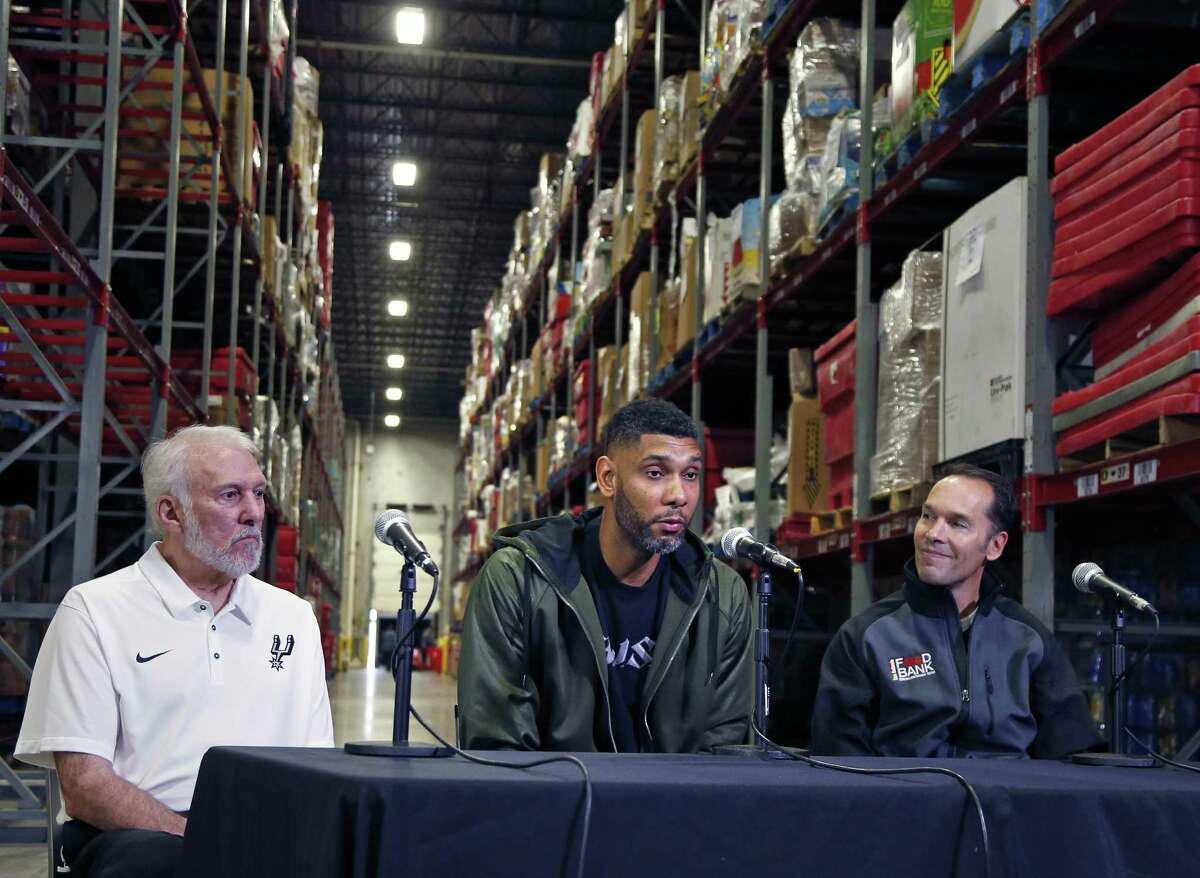 Retired Spurs superstar Tim Duncan, flanked by San Antonio Food Bank CEO Eric S. Cooper, right, and Spurs Coach Gregg Popovich, on Tuesday announced a matching challenge in which he will donate up to $500,000 to help feed hungry families this holiday season. For each $1 donated to the food bank, Duncan will contribute $2 until the half-million-dollar mark is reached.