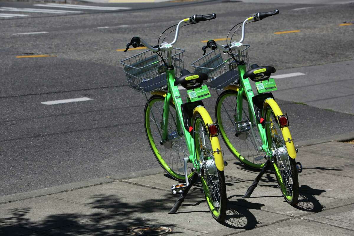 LimeBike, one of a handful of dockless bike companies interesting in distributing bikes around Houston, like these two in Seatlle's lower Queen Anne neighborhood on July 26, 2017. Bikes are unlocked via an app and do not come with helmets.