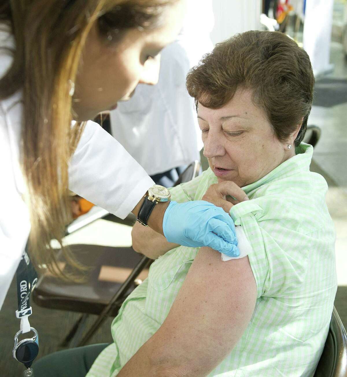 FILE — In this file photo, Stamford Public Schools employee Jeanie Valentine gets a flu shot at the government center.