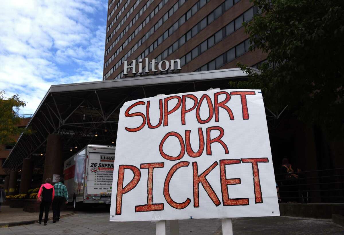 Picketers with the Hotel Trades Council protest outside the Hilton on Lodge Street on Friday, Oct. 13, 2017, in Albany, N.Y. The union that represents employees at the Hilton Albany is pressing for a requirement in a new labor contract that panic buttons be distributed to hotel staff. (Will Waldron/Times Union archive)