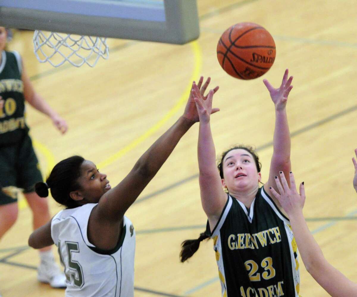 Sacred Heart’s Laura Holland, left, battling for a rebound with Casey Gottlieb of Greenwich Academy in a Feb. 23 game, will serve as a co-captain for the Tigers this season.