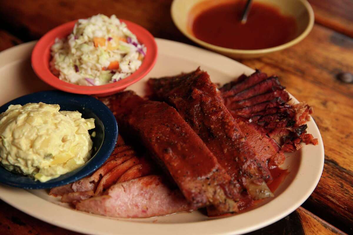 The Sampler plate from Hickory Hollow's original Fallbrook location has beef brisket, sausage and ribs with side dishes of potato salad and coleslaw on Friday, Dec. 1, 2017, in Houston. ( Yi-Chin Lee / Houston Chronicle )
