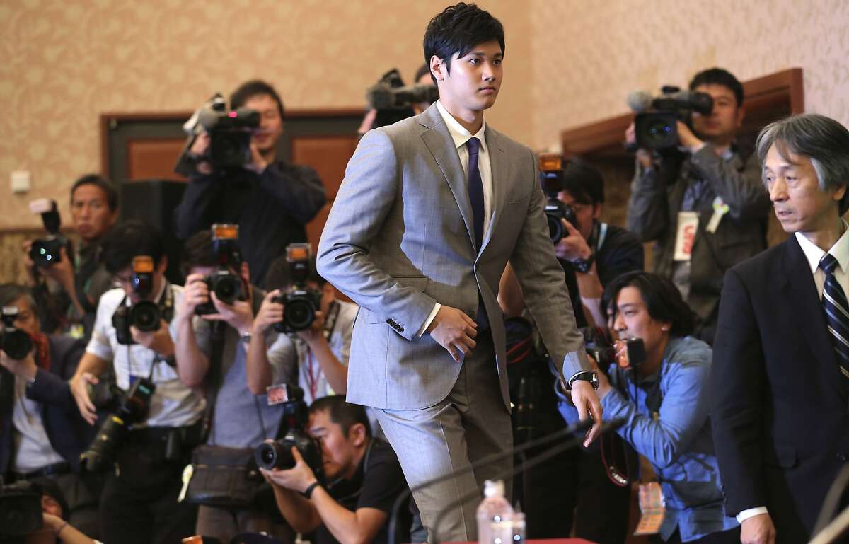 Japanese pitcher-outfielder Shohei Otani arrives for a press conference at Japanese National Press Center in Tokyo, Saturday, Nov. 11, 2017. Highly touted Japanese pitcher-outfielder Shohei Otani announced on Saturday he wants to move to Major League Baseball next season. (AP Photo/Koji Sasahara)