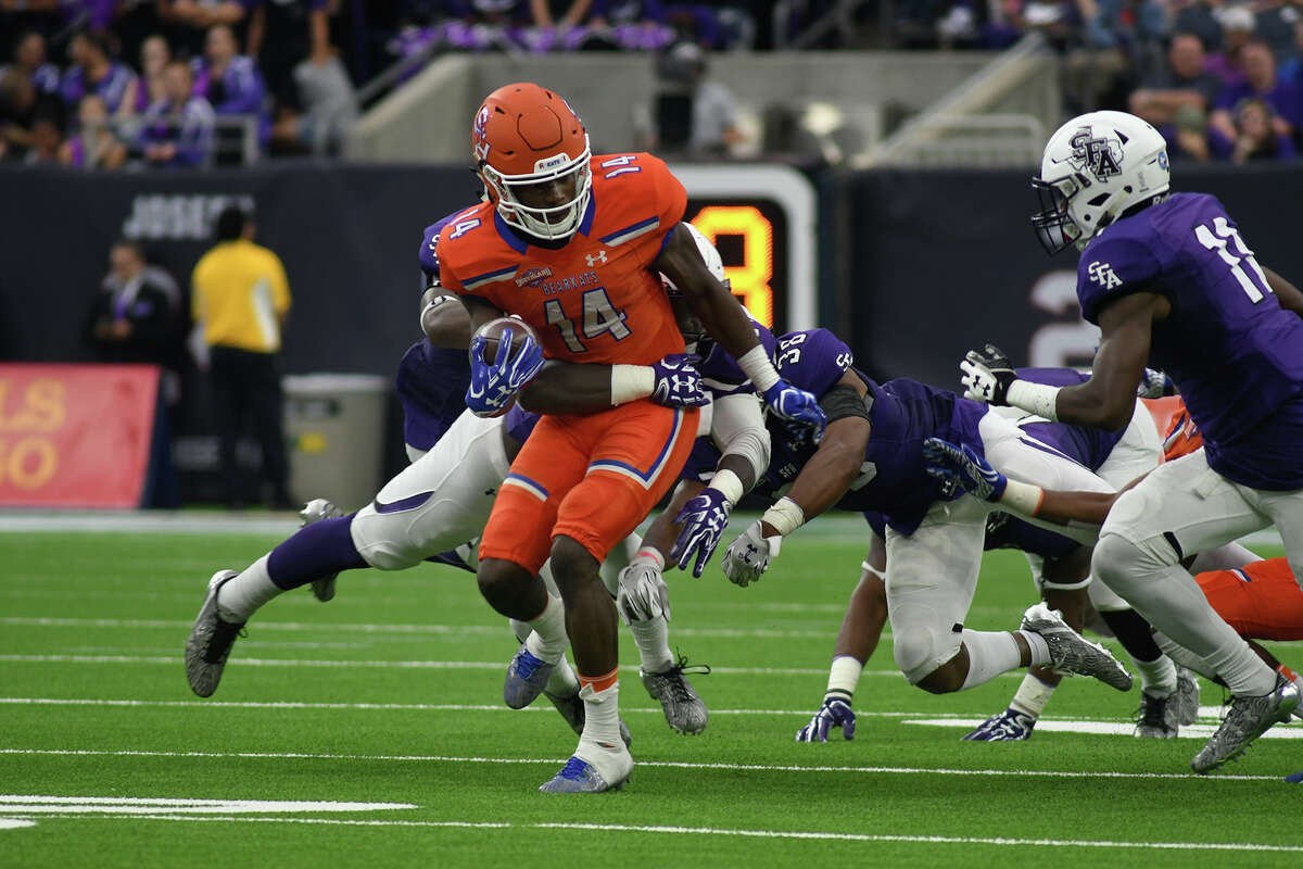 Sam Houston State junior wide receiver Davion Davis (14) tries to break free of a Stephen F. Austin defender during their Battle of the Piney Woods clash at NRG Stadium in Houston on Saturday, Oct. 7, 2017. (Photo by Jerry Baker/Freelance)