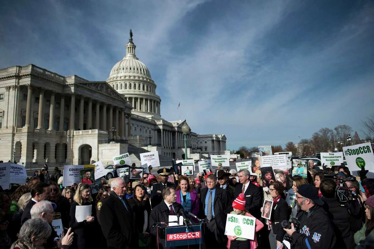 People gather during an event on Capitol Hill opposing concealed carrying of guns December 6, 2017 in Washington, DC. US lawmakers were expected to vote Wednesday to let gun owners carry concealed firearms across state lines, a controversial bill that critics say is aimed at undermining national gun control efforts.