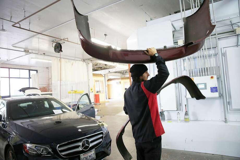 Julio Saucedo, body technician, carries parts of a car through George V. Arth & Son to the painting area of the business on Monday, November 20, 2017 in Oakland, Calif. Photo: Lea Suzuki, The Chronicle