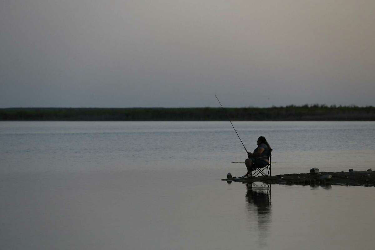 A woman tries you luck while fishing at Falcon Lake in Zapata, Texas, Sunday, April 30, 2017.