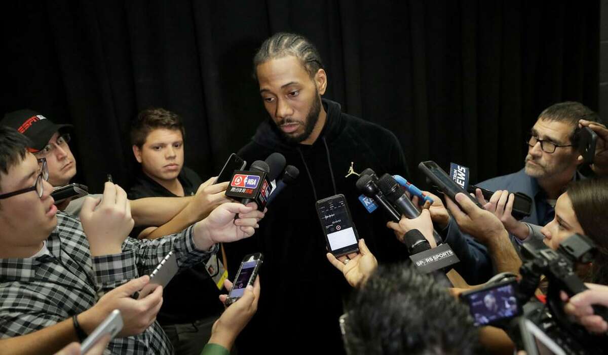 San Antonio Spurs forward Kawhi Leonard, who has not played this season due to an injury, talks with the media before an NBA basketball game against the Detroit Pistons, Monday, Dec. 4, 2017, in San Antonio. Leonard is expected to return to play soon.