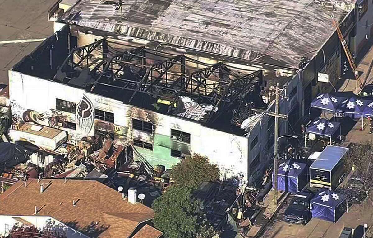 FILE- This Dec. 3, 2016, file image from video provided by KGO-TV shows the Ghost Ship Warehouse after a fire swept through the building in Oakland, Calif. Prosecutors are trying to persuade Alameda County Judge Jeffrey Horner that Derick Almena and Max Harris should stand trial on involuntary manslaughter charges in connection with the Oakland, Calif., warehouse fire that would become the site of the country's deadliest building fire in more than a decade. (KGO-TV via AP, File)