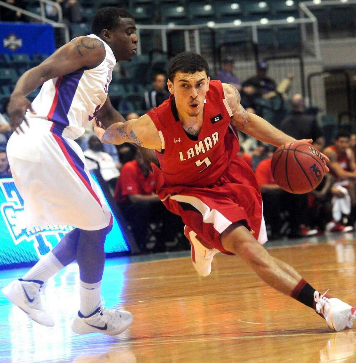 Lamar's Mike James drives around SFA's Antonio Bostic at the Merrell Center in Katy, Thursday, March 8, 2012. Tammy McKinley/The Enterprise