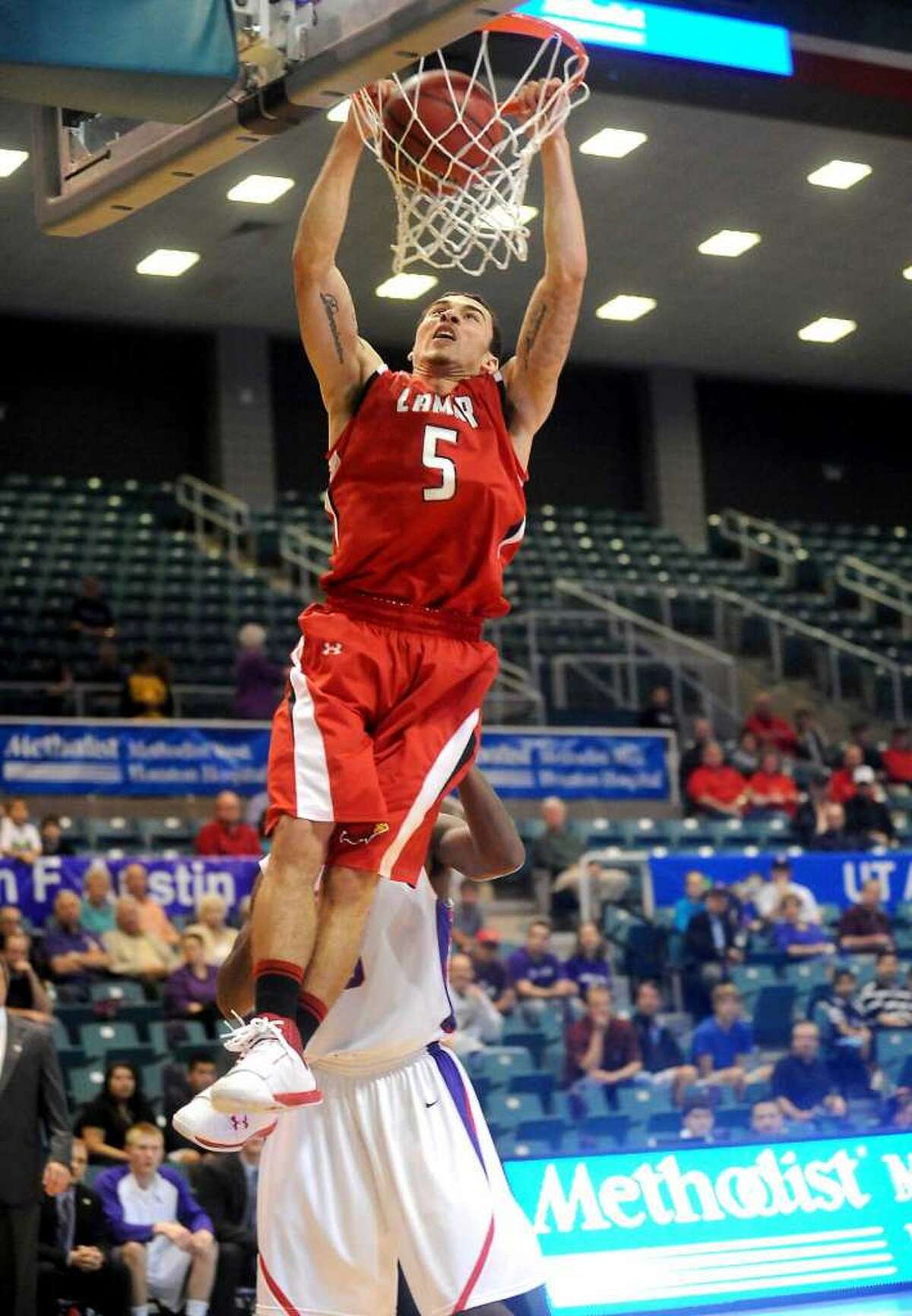 Lamar's Mike James puts it in the basket during the game against Stephen F. Austin at the Merrell Center in Katy, Thursday, March 8, 2012. Tammy McKinley/The Enterprise