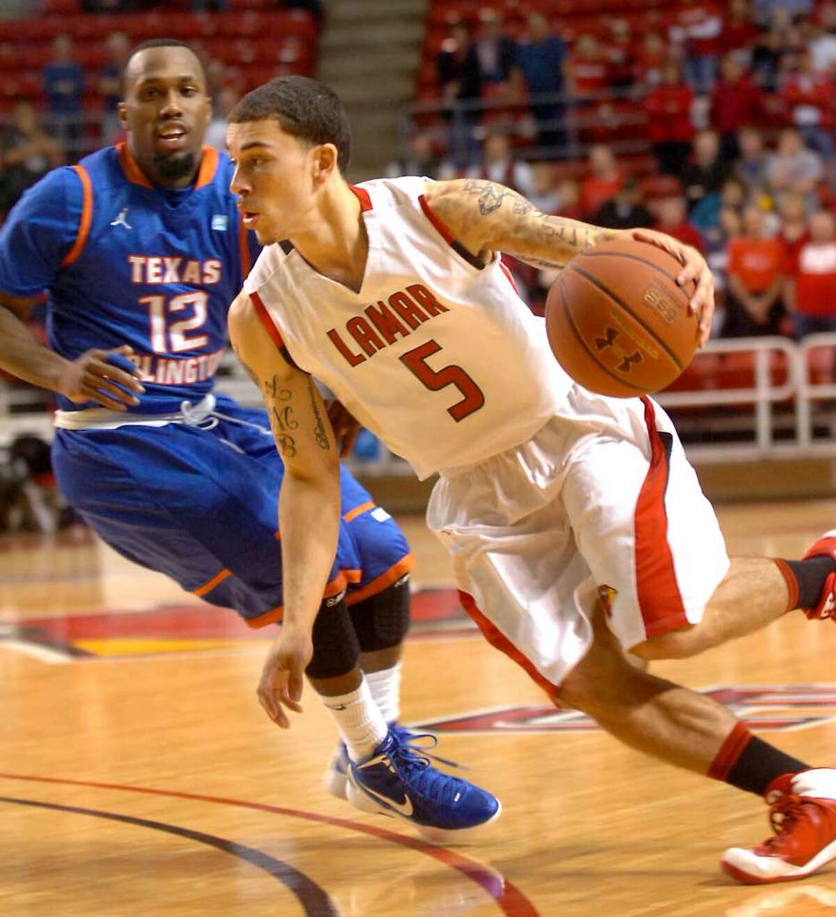 Lamar's Mike James drives around UT-Arlington's Shaquille White-Miller at the Montagne Center at Lamar University in Beaumont, Saturday, January 14, 2012. Tammy McKinley/The Enterprise