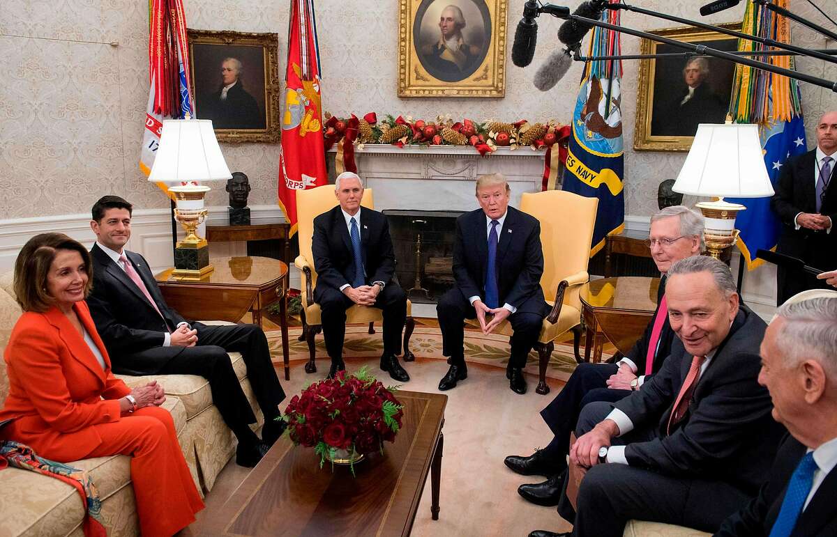 US President Donald Trump, alongside Vice President Mike Pence (3L), meets with Congressional leadership including Senate Majority Leader Mitch McConnell (3R), Republican of Kentucky, Senate Minority Leader Chuck Schumer (2R), Democrat of New York, Speaker of the House Paul Ryan (2nd L), Republican of Wisconsin, and House Democratic Leader Nancy Pelosi (L), Democrat of California, and Secretary of Defense Jim Mattis (R), in the Oval Office at the White House in Washington, DC, December 7, 2017. / AFP PHOTO / SAUL LOEBSAUL LOEB/AFP/Getty Images