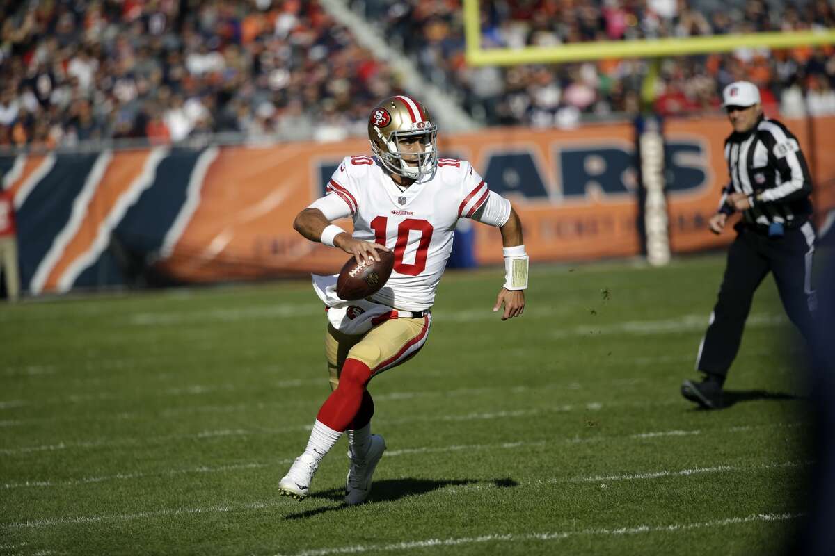 San Francisco 49ers quarterback Jimmy Garoppolo (10) scrambles during the first half of an NFL football game against the Chicago Bears, Sunday, Dec. 3, 2017, in Chicago. (AP Photo/Nam Y. Huh)