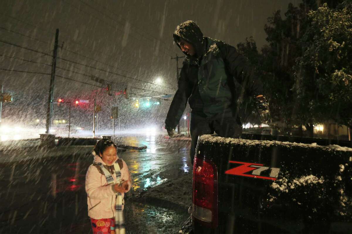 Siblings Ivan Moncada and Sofia Barrientos have fun as snow falls in San Antonio on Thursday, Dec. 7, 2017. Not since 2011, San Antonio residents experienced a bout of snow just after sunset which gave children and adults a chance to experience a winter wonderland in a city that mostly never sees the frosty precipitation. (Kin Man Hui/San Antonio Express-News)