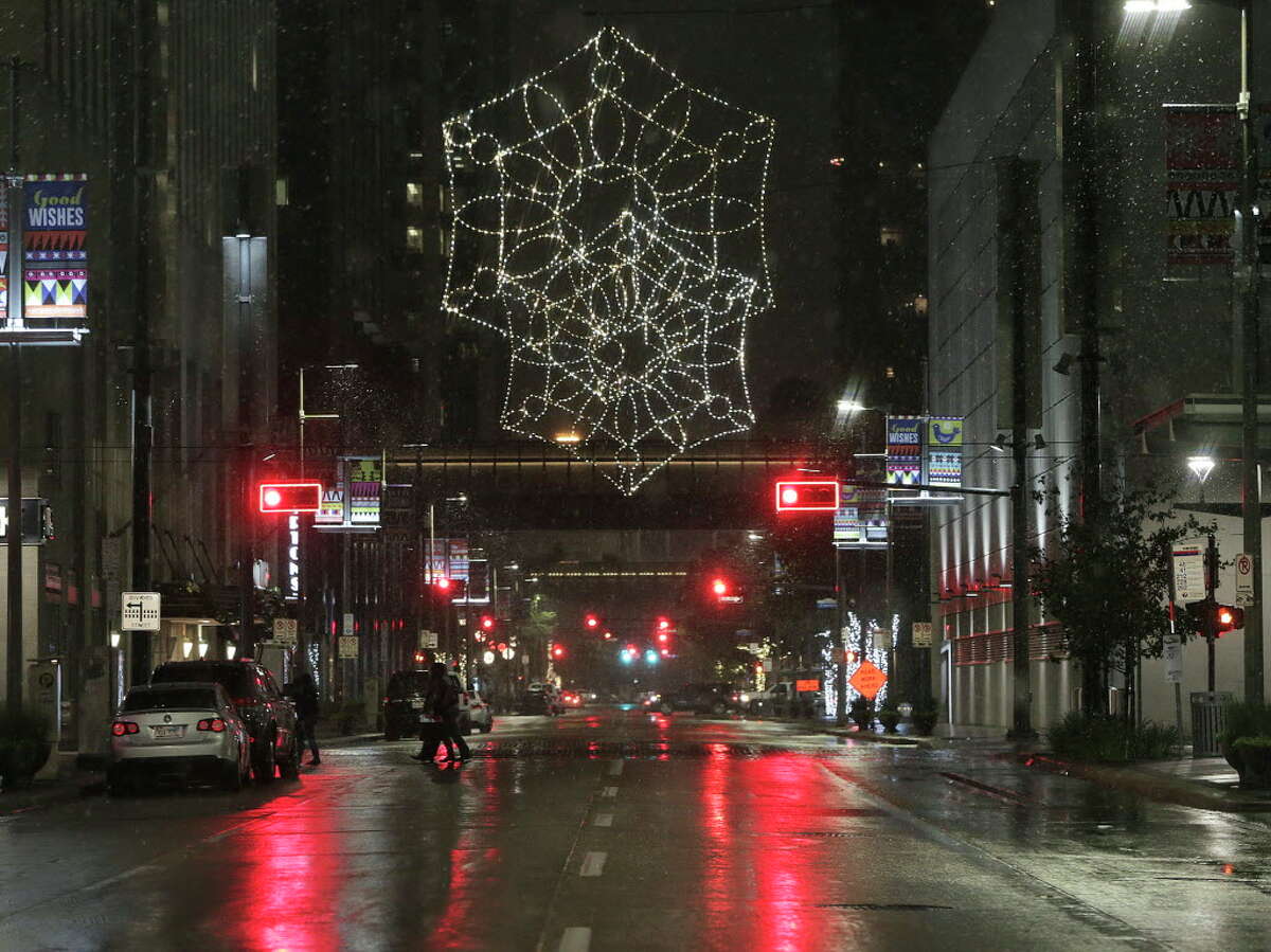Snow falls in downtown on Thursday, Dec. 7, 2017, in Houston.