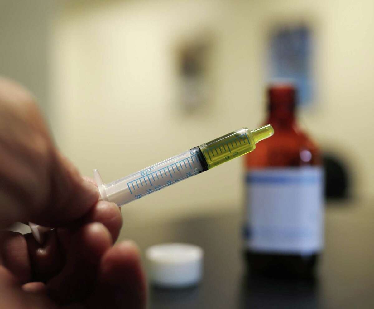 In this Monday, Nov. 6, 2017, photo, a syringe loaded with a dose of CBD oil is shown in a research laboratory at Colorado State University in Fort Collins, Colo. People anxious to relieve suffering in their pets are increasingly turning to oils and powders that contain CBDs, a non-psychoactive component of marijuana.