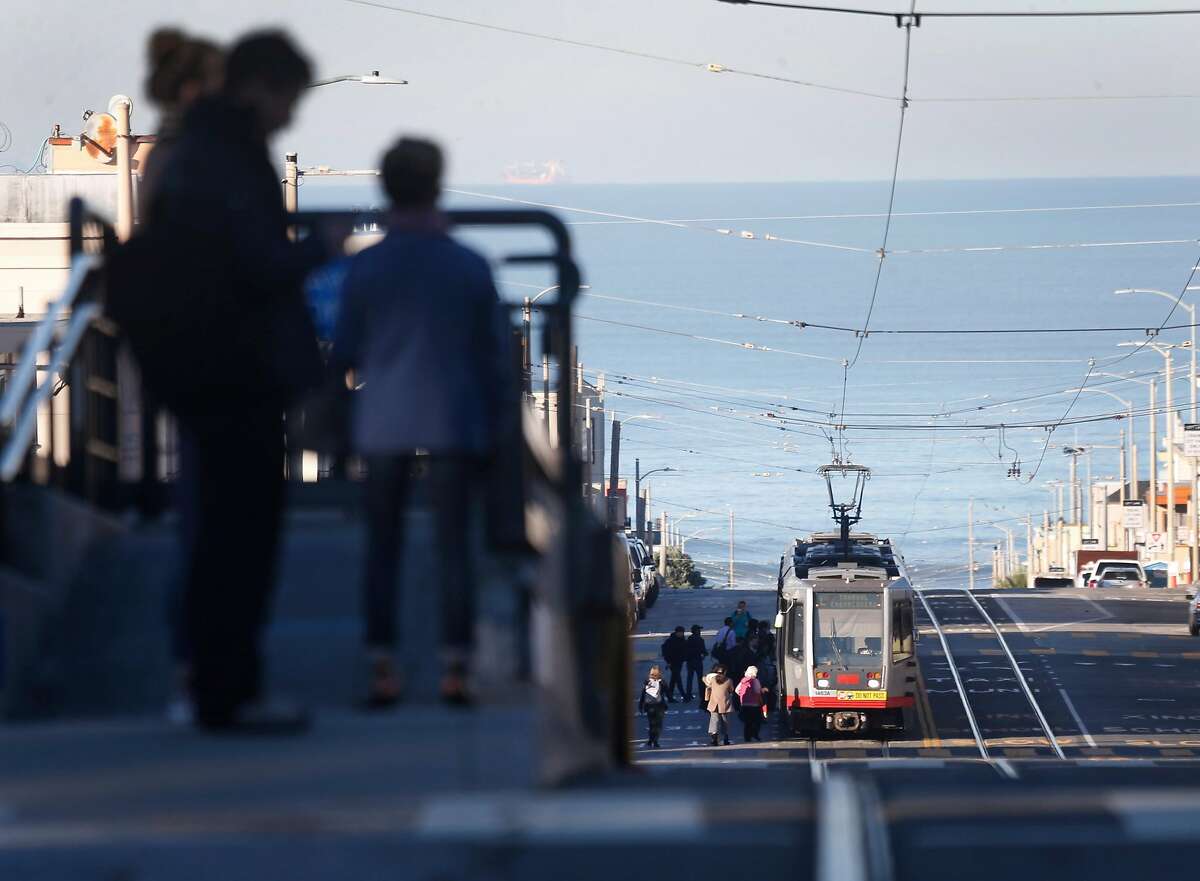 Passengers wait for an L-Taraval Muni Metro streetcar from a raised platform at Sunset Boulevard in San Francisco, Calif. on Wednesday, Dec. 6, 2017.