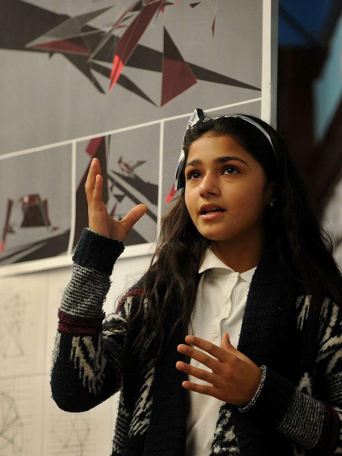 Sixth grader Milayna Roman, 11, presents her architecture project that she completed as part of the Thom Mayne Young Architects program at Hall School in Bridgeport, Conn. on Tuesday, December 5, 2017. Students learned to use a computer design program to artistically reimagine their classroom space.