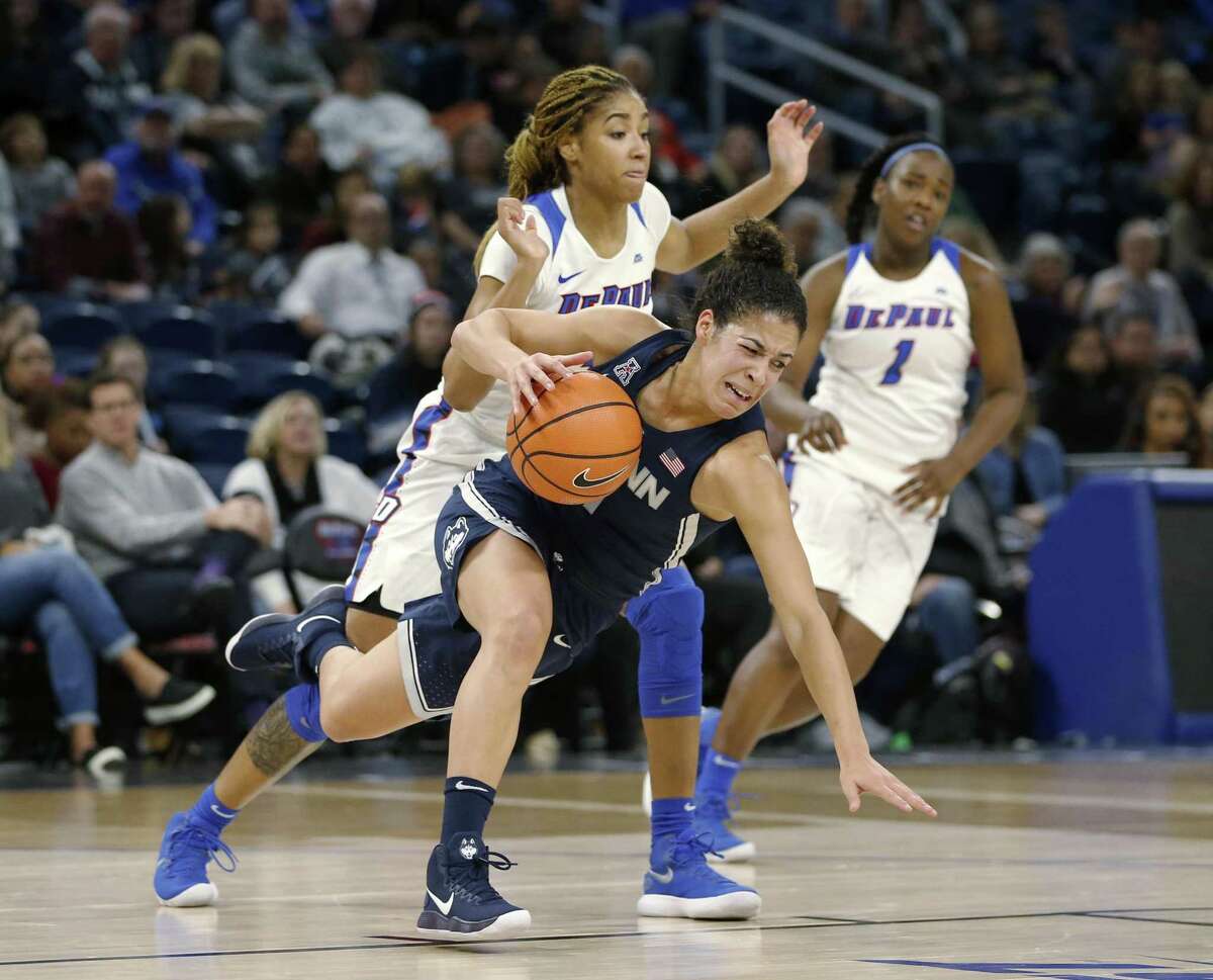 UConn’s Kia Nurse, front, is tripped by DePaul forward Mart'e Grays during the first half on Friday.