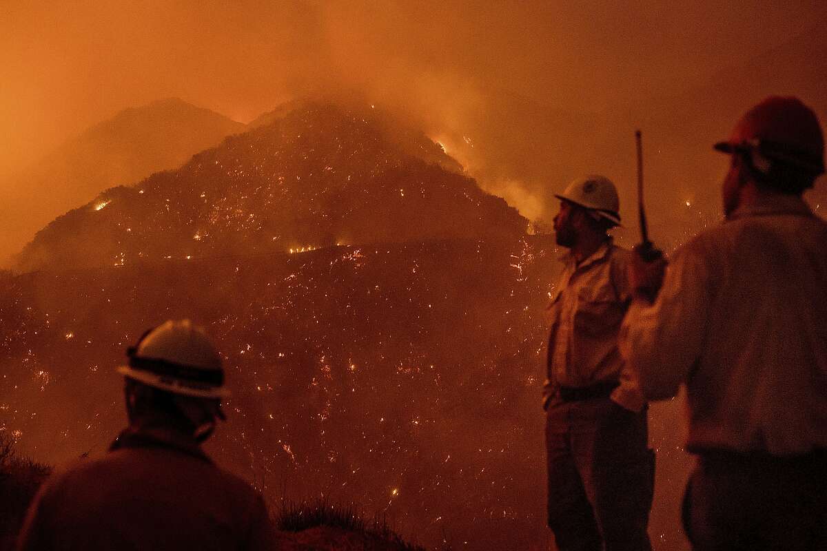 Firefighters monitor the Thomas fire as it burns through Los Padres National Forest near Ojai, Calif., on Friday, Dec. 8, 2017. (AP Photo/Noah Berger)
