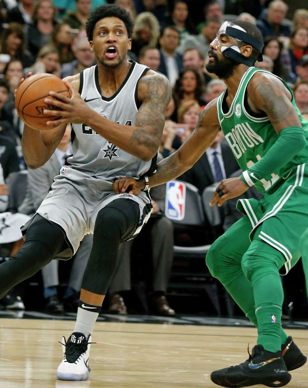 San Antonio Spurs forward Rudy Gay (22) drives around Boston Celtics guard Kyrie Irving (11) during second half action Friday Dec. 8, 2017 at the AT&T Center.
