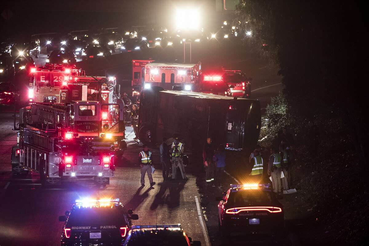 Emergency responders work at the scene of an overturned passenger bus on southbound Highway101 north of Cesar Chavez Boulevard in San Francisco, Calif. on Friday, Dec. 8, 2017.
