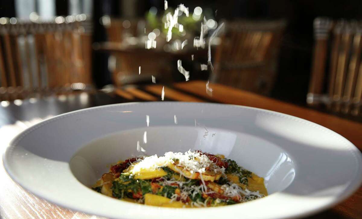 The agnolotti with acorn squash, pine nuts, and wilted Tuscan kale in a saffron butter sauce.