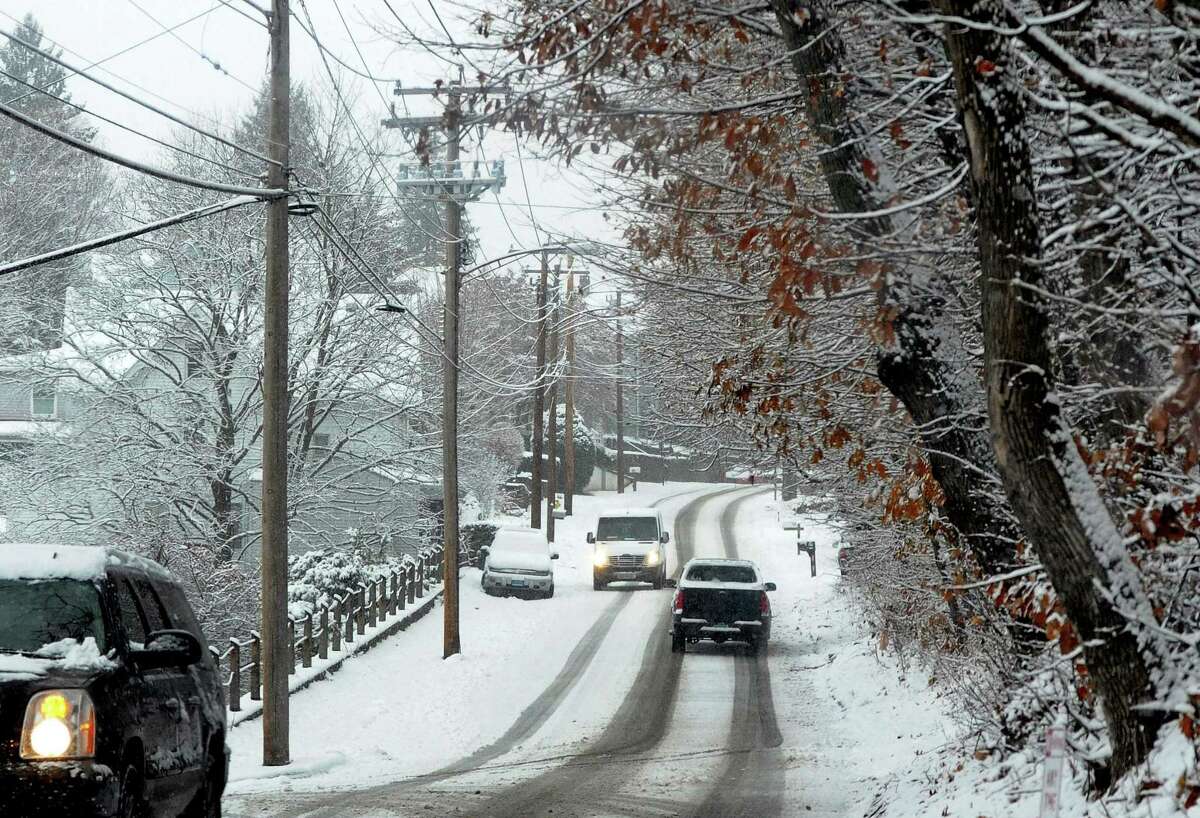 A view of snow covering North Ave in Derby, Conn., on Saturday Dec. 9, 2017. Original forecasts predicted double the amount of snow that actually fells in the region.