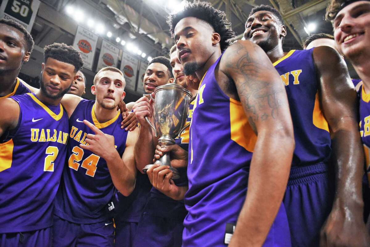 UAlbany celebrates with the Albany Cup after beating Siena at the Times Union Center Saturday Dec. 9, 2017 in Albany, NY. (John Carl D'Annibale / Times Union)