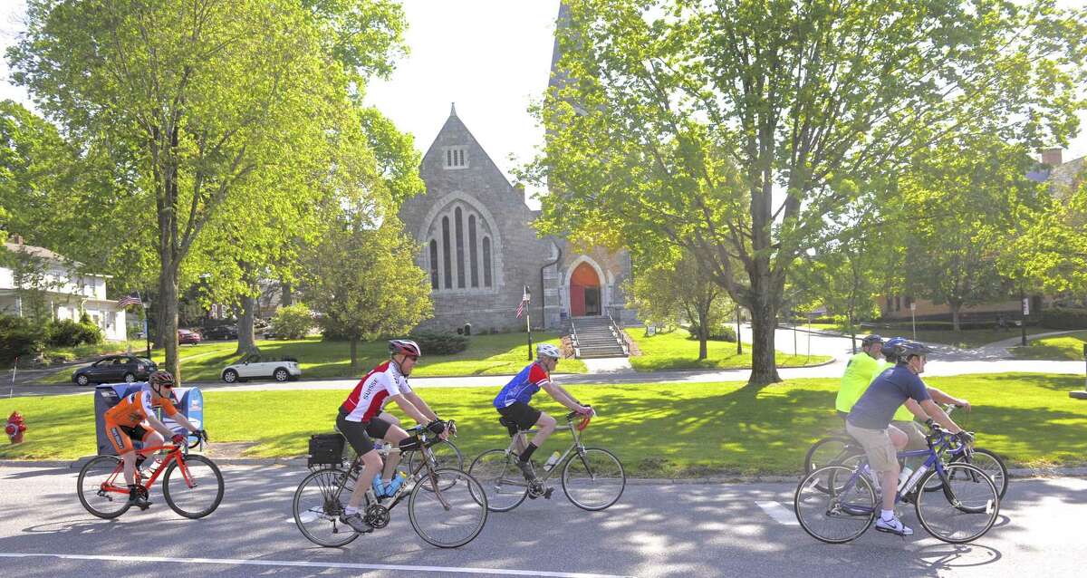 Cyclist ride down Main Street on their way to Town Hall during the second annual Bike to Work event Friday, May 19, 2017, in New Milford, Conn.