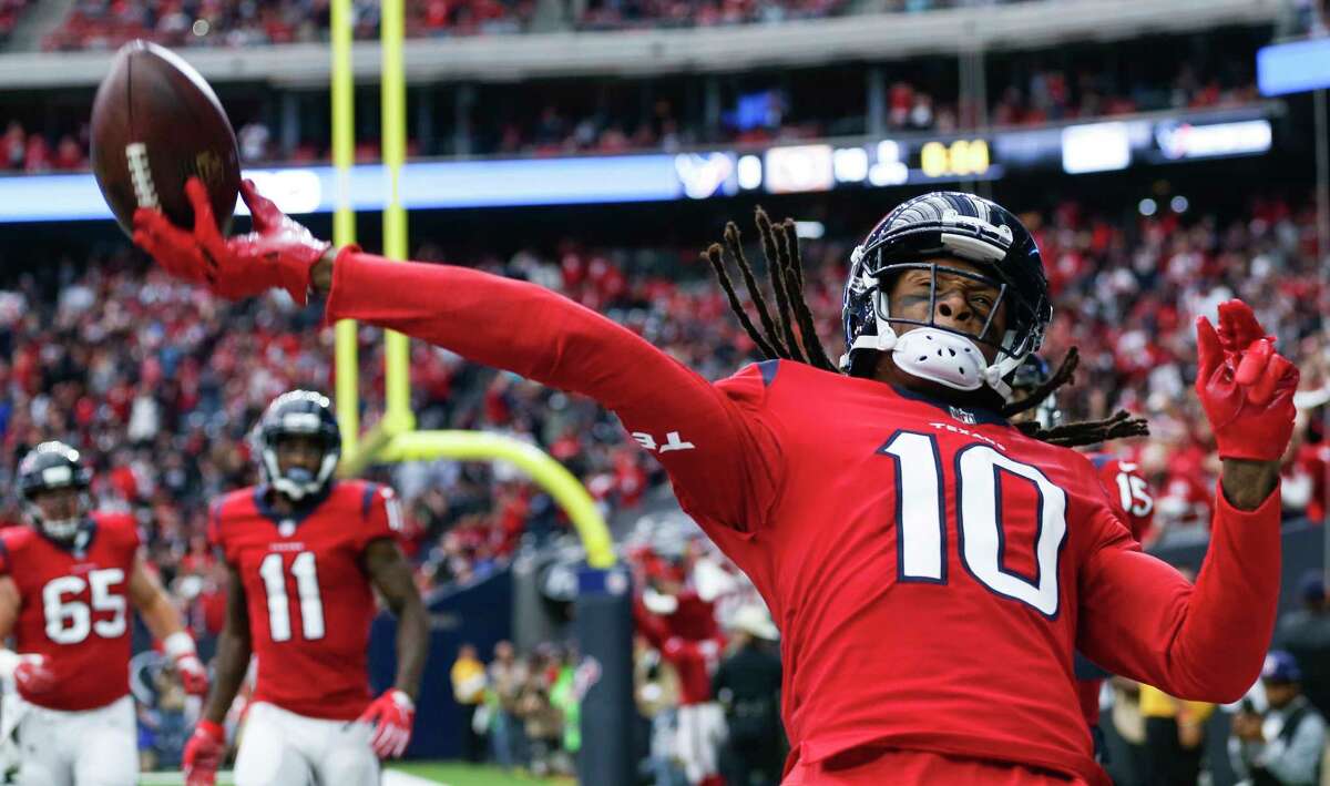 Houston Texans wide receiver DeAndre Hopkins (10) throws the football into the crowd after scoring on a 7-yard touchdown reception from quarterback T.J. Yates against the San Francisco 49ers during the second quarter of an NFL football game at NRG Stadium on Sunday, Dec. 10, 2017, in Houston.