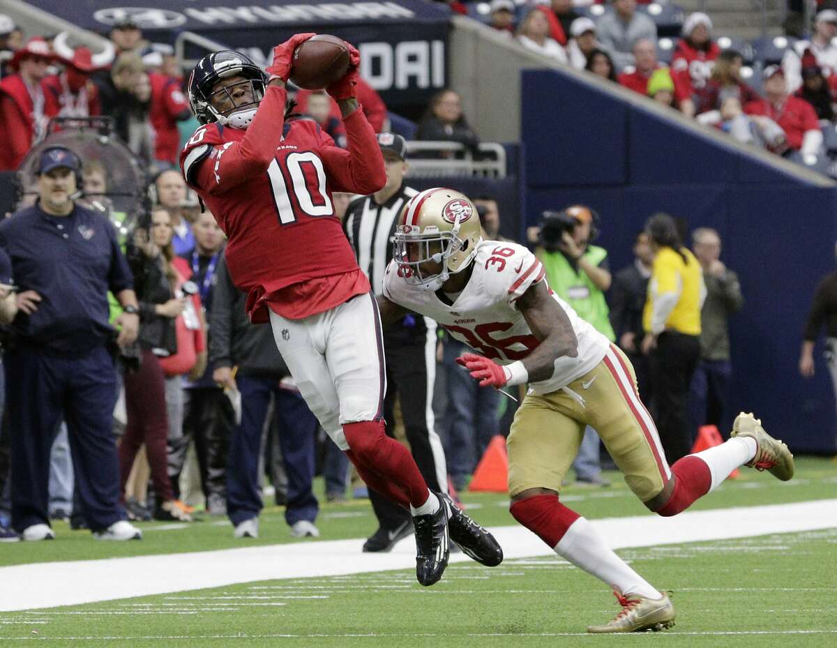 Houston Texans wide receiver DeAndre Hopkins (10) catches a pass over San Francisco 49ers cornerback Dontae Johnson (36) during the second half of an NFL football game Sunday, Dec. 10, 2017, in Houston. (AP Photo/Michael Wyke)