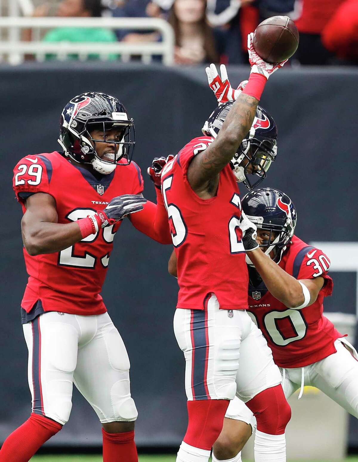 Houston Texans defensive backs Kareem Jackson (25), Andre Hal (29) and Kevin Johnson (30) celebrate Jackson's interception of a pass by San Francisco 49ers quarterback Jimmy Garoppolo during the first quarter of an NFL football game at NRG Stadium on Sunday, Dec. 10, 2017, in Houston.