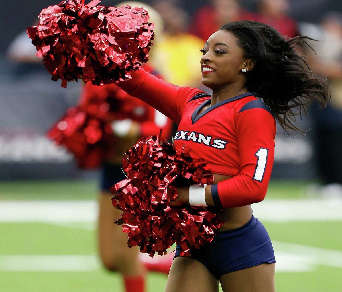 Honorary Houston Texans cheerleader and Olympic gold medalist Simone Biles performs with the cheerleaders during the game against the San Francisco 49ers at NRG Stadium on December 10, 2017 in Houston, Texas.