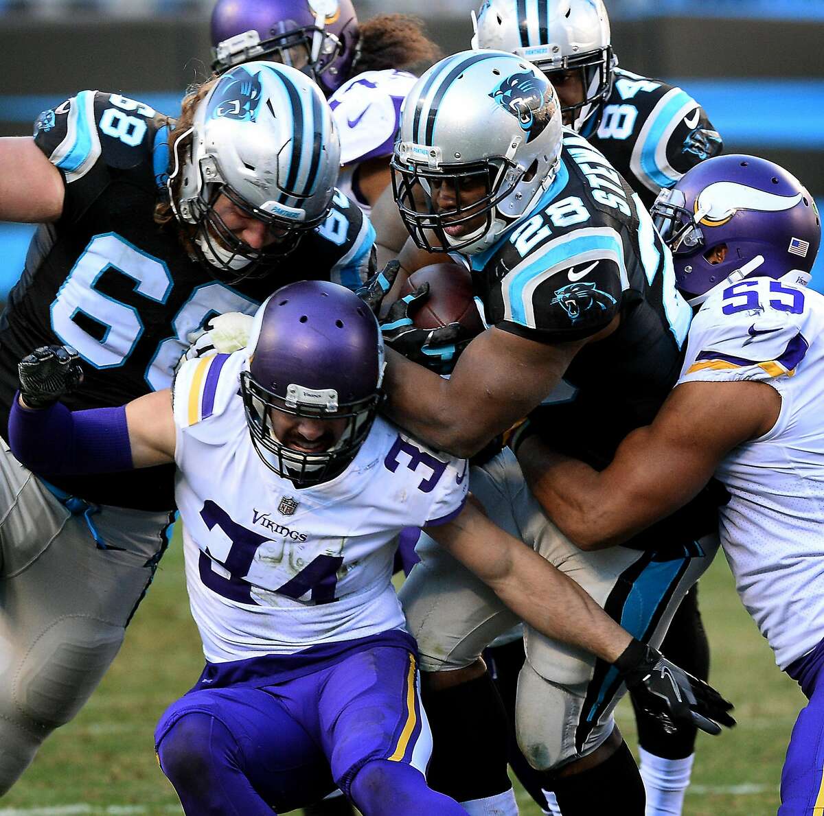 Carolina Panthers running back Jonathan Stewart, center/right, keeps pushing forward on a run as Minnesota Vikings safety Andrew Sendejo, left, and linebacker Anthony Barr, right, try to make the stop during fourth quarter action on Sunday, Dec. 10, 2017 at Bank of America Stadium in Charlotte, N.C. The Panthers defeated the Vikings 31-24. (Jeff Siner/Charlotte Observer/TNS)
