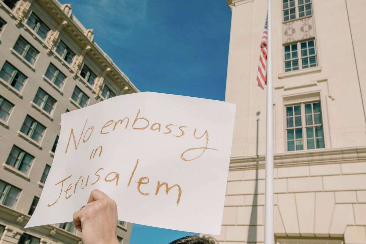 A protestor lifts his sign during a rally on Sunday December 10, 2017 at the Hipolito F. Garcia Federal Building and Courthouse in San Antonio, TX where people gathered to protest President Trump's plan to move the U.S. Embassy from Tel Aviv to Jerusalem.