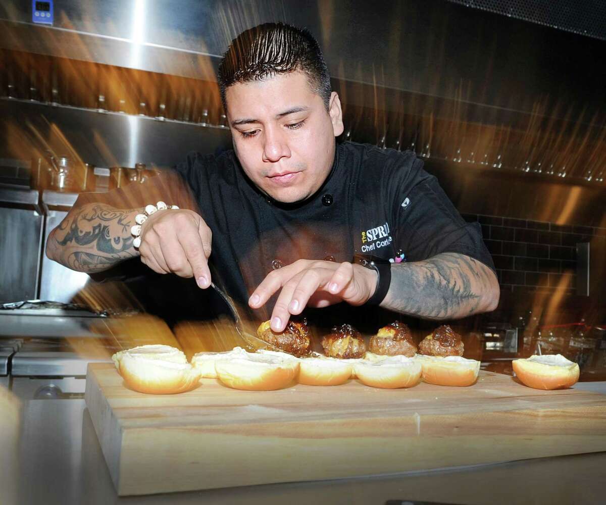 Chef Carlos Baez prepared Kobe beef sliders during the media night preview at The Spread restaurant in Greenwich, Conn., Friday, Dec. 8, 2017. Baez is one of the owners of the restaurant.