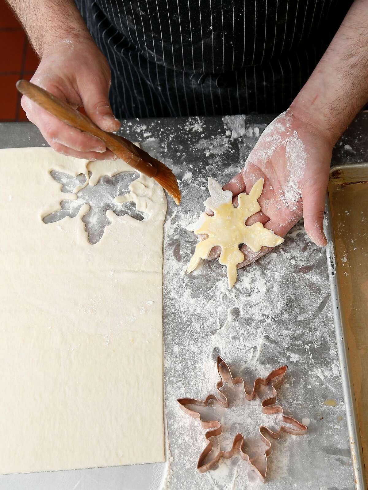 Chef Blake Askew makes snowflake decorations from dough for his beef wellington at Maybeck's on Tuesday, November 29, 2017, in San Francisco, Calif.