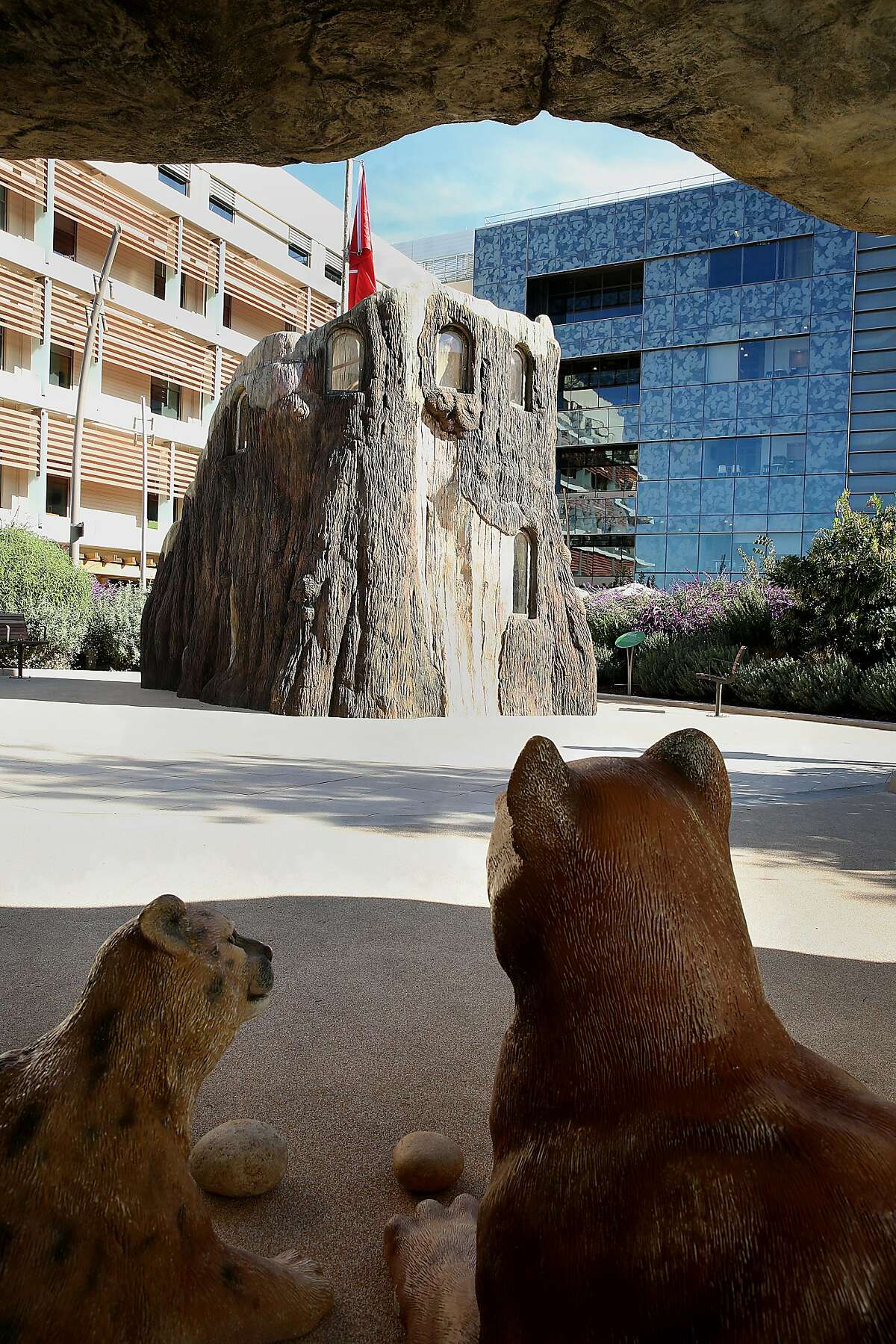 View of the playground fort and the new Lucile Packard Children's Hospital from the puma den of Dunlevie garden on Wednesday, December 6, 2017, in Palo Alto, CA.