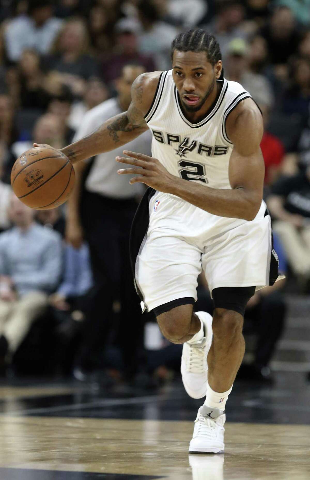 After a steal, San Antonio Spurs' Kawhi Leonard drives the ball during the first half against the New Orleans Pelicans at the AT&T Center, Wednesday, March 30, 2016.