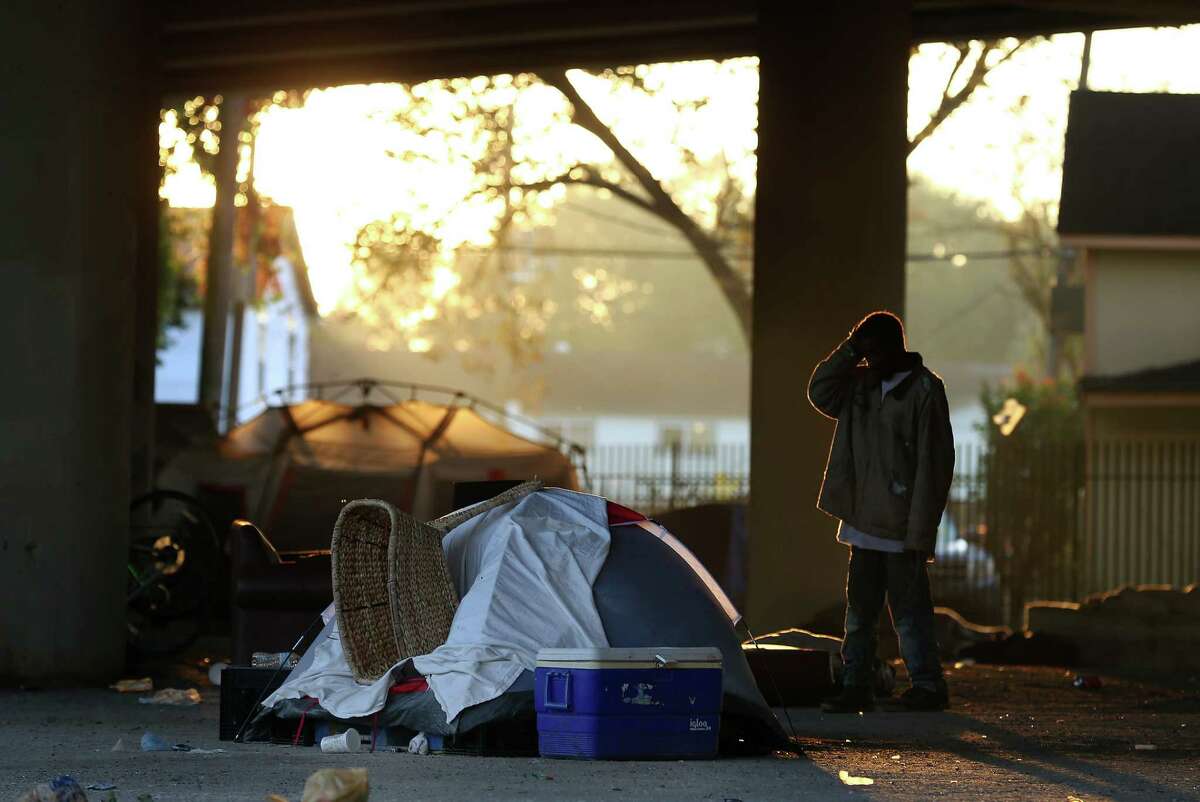 A man stands in front of his tent before having to move his belongings so that City officials conduct a cleanup of the homeless encampment that is located under the U.S. 59 Highway, between Caroline Street and Almeda Road Wednesday, Nov. 15, 2017, in Houston. ( Godofredo A. Vasquez / Houston Chronicle )