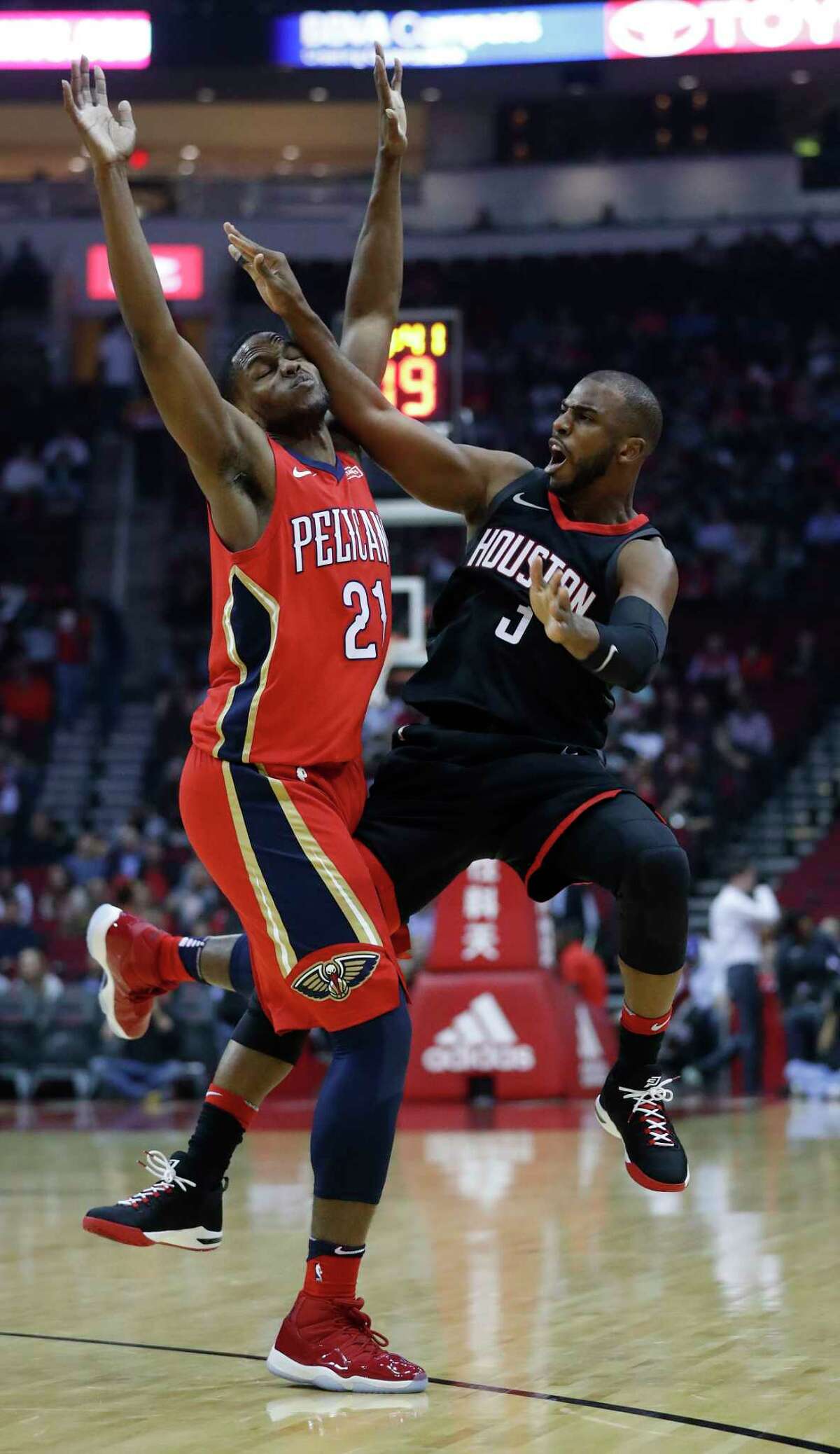 Houston Rockets guard Chris Paul (3) tries to shoot a three-pointer over New Orleans Pelicans forward Darius Miller (21) during the first half of an NBA game at Toyota Center, Monday, Dec. 11, 2017, in Houston.
