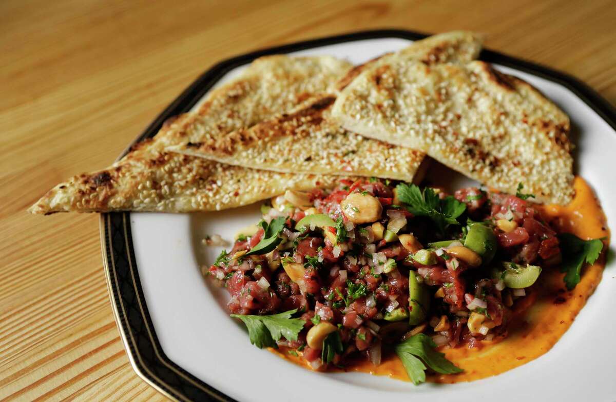Lamb tartare with green olives and almonds served with a sesame seed-crusted flat bread at Nancy's Hustle.