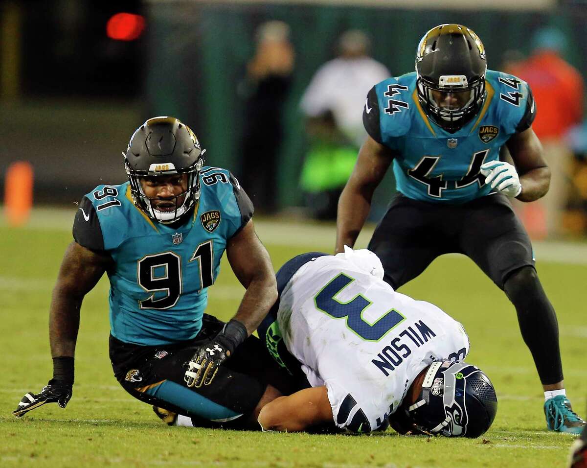 Seattle Seahawks quarterback Russell Wilson (3) is sacked by Jacksonville Jaguars defensive end Yannick Ngakoue (91) and Myles Jack (44) during the second half of an NFL football game, Sunday, Dec. 10, 2017, in Jacksonville, Fla. (AP Photo/Stephen B. Morton)