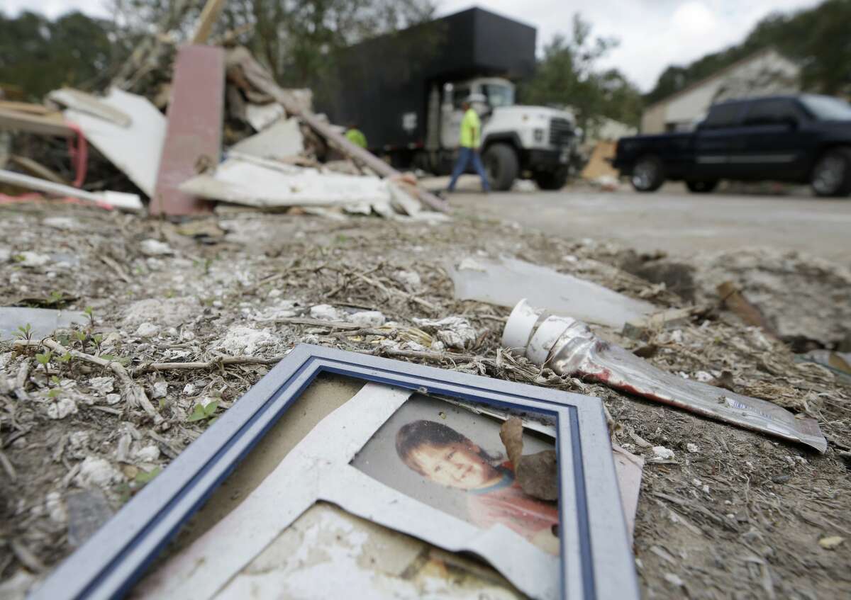 A photograph lays in the debris in Bear Creek, a neighborhood in the Addicks reservoir flood pool.